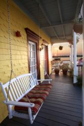 summer florida getaway, porch swing, sunset over water